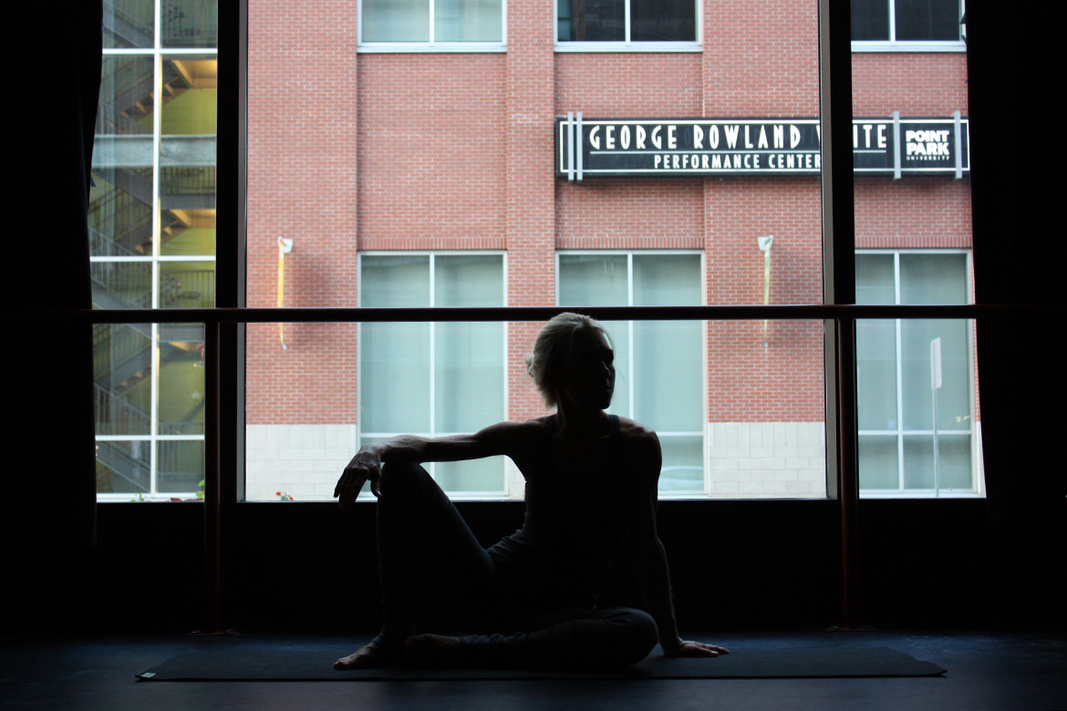 girl sitting on natural green Jade yoga mat after yoga