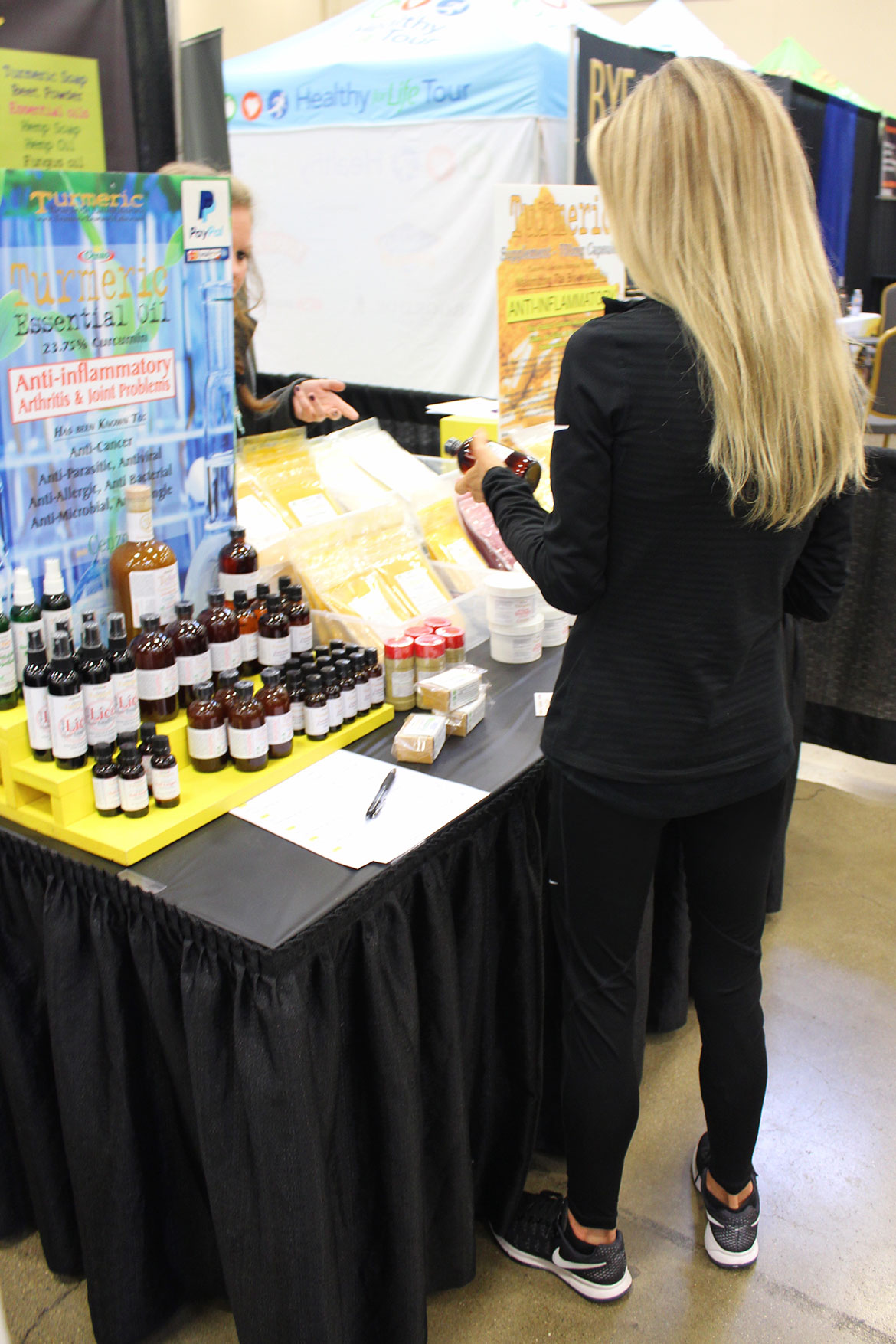 Looking at Beauty Products and Turmeric Essential Oils at a Fitness Expo