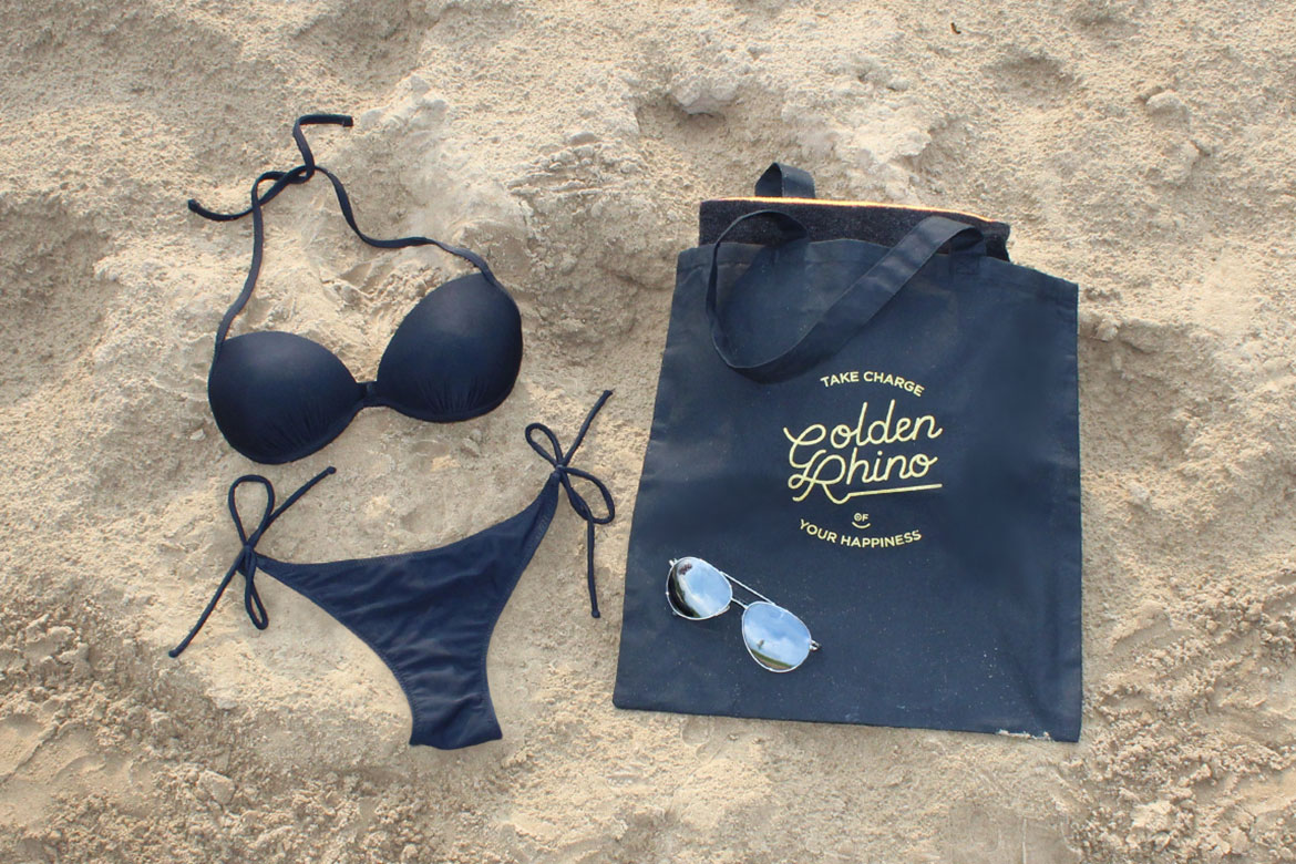 Beach trip with Golden Rhino’s tote, black bikini and aviators