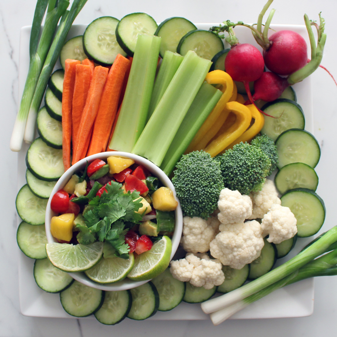 Healthy and Fresh Mood Boosting Mango Salsa on a Vegetable Tray